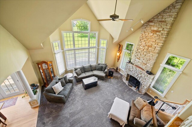 36W850 Red Gate Ct, Saint Charles, IL 60175 - living area featuring high vaulted ceiling, ceiling fan, plenty of natural light, a stone fireplace, and wood finished floors