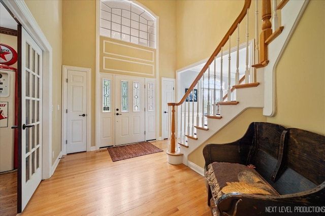 36W850 Red Gate Ct, Saint Charles, IL 60175 - foyer featuring wood finished floors, a high ceiling, stairway, and baseboards