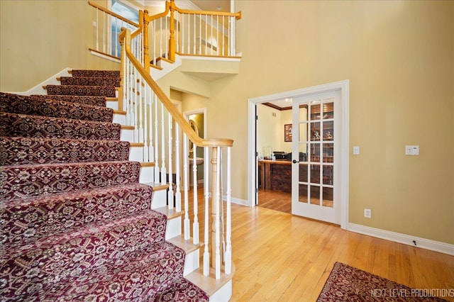 36W850 Red Gate Ct, Saint Charles, IL 60175 - staircase featuring hardwood / wood-style flooring, baseboards, and a towering ceiling