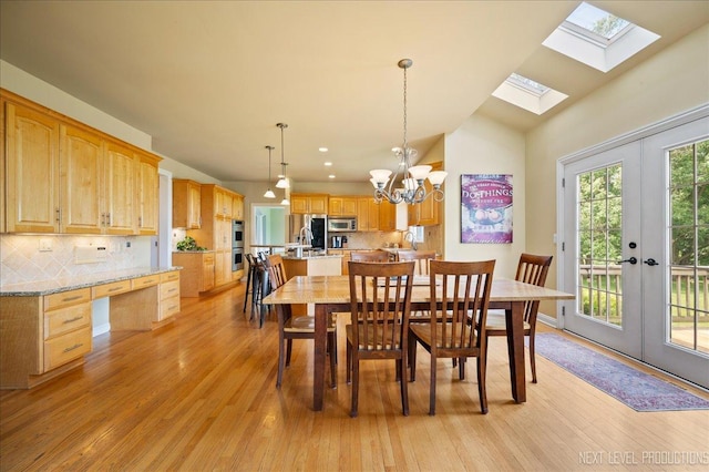 36W850 Red Gate Ct, Saint Charles, IL 60175 - dining area featuring light wood-style flooring, a skylight, a chandelier, lofted ceiling, and french doors