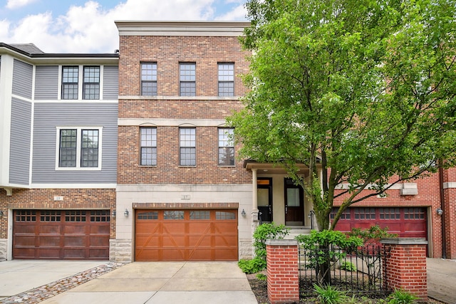 17 Virginia Pkwy, Schaumburg, IL 60193 - townhome / multi-family property with a garage, concrete driveway, and brick siding