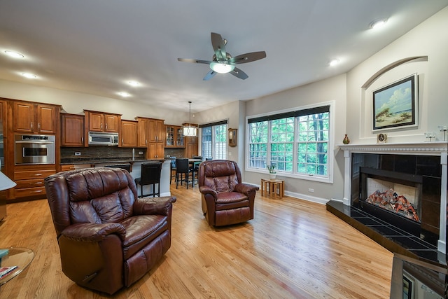 17 Virginia Pkwy, Schaumburg, IL 60193 - living area with light wood finished floors, ceiling fan, a fireplace, baseboards, and recessed lighting