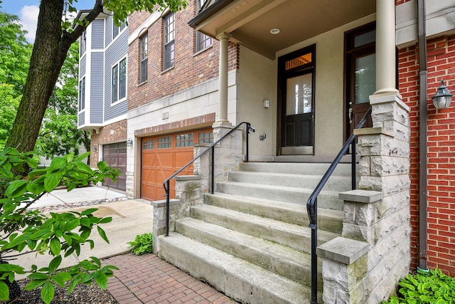 17 Virginia Pkwy, Schaumburg, IL 60193 - doorway to property featuring brick siding, an attached garage, and driveway