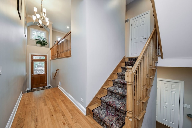 17 Virginia Pkwy, Schaumburg, IL 60193 - entrance foyer featuring a chandelier, baseboards, stairs, a towering ceiling, and light wood-style flooring