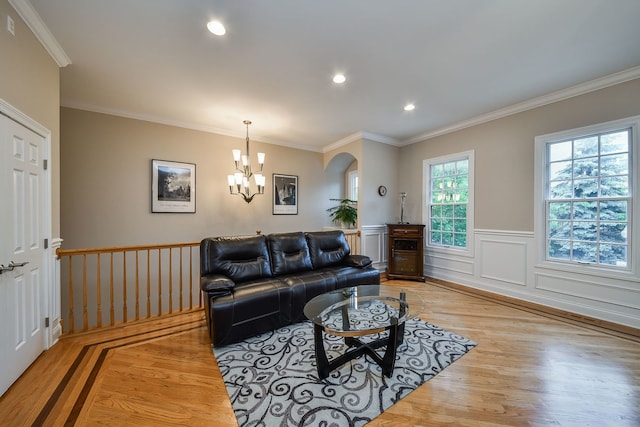 17 Virginia Pkwy, Schaumburg, IL 60193 - living room with light wood finished floors, a chandelier, crown molding, arched walkways, and a wainscoted wall