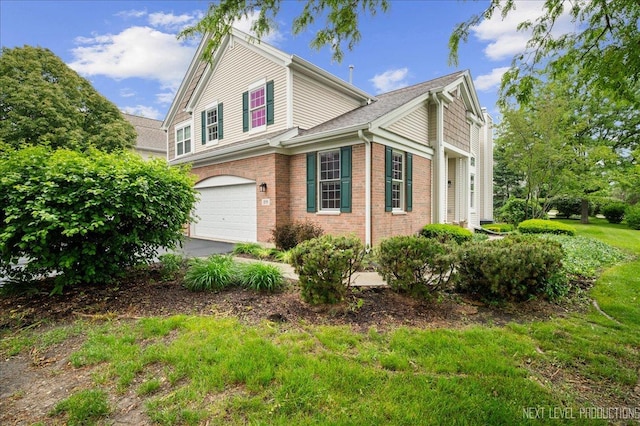 211 Trentt Dr Unit 211, Batavia, IL 60510 - view of property exterior with a garage, brick siding, and driveway