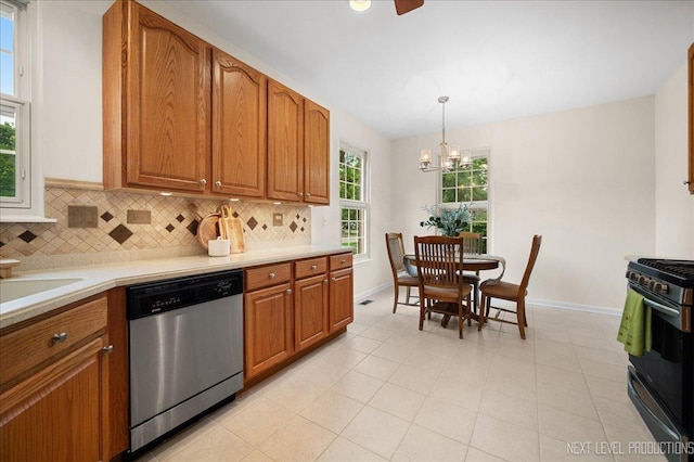 211 Trentt Dr Unit 211, Batavia, IL 60510 - kitchen with appliances with stainless steel finishes, a chandelier, tasteful backsplash, and brown cabinets