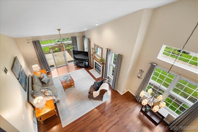 211 Trentt Dr Unit 211, Batavia, IL 60510 - living room featuring plenty of natural light, wood finished floors, baseboards, and a high ceiling