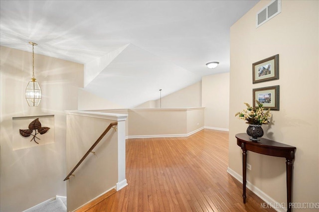 211 Trentt Dr Unit 211, Batavia, IL 60510 - hallway with an upstairs landing, hardwood / wood-style flooring, baseboards, and vaulted ceiling