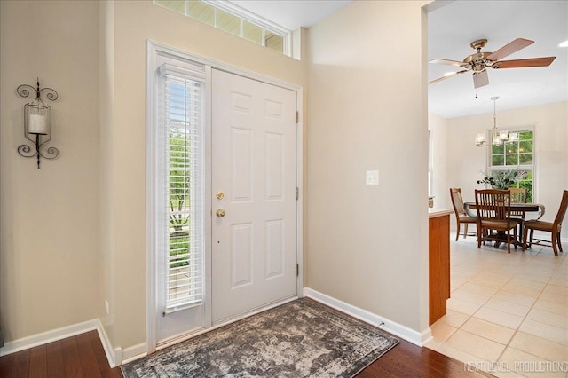 211 Trentt Dr Unit 211, Batavia, IL 60510 - foyer entrance with baseboards, a chandelier, light wood-style floors, and ceiling fan