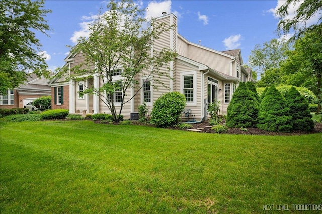 211 Trentt Dr Unit 211, Batavia, IL 60510 - rear view of property with a yard and a chimney