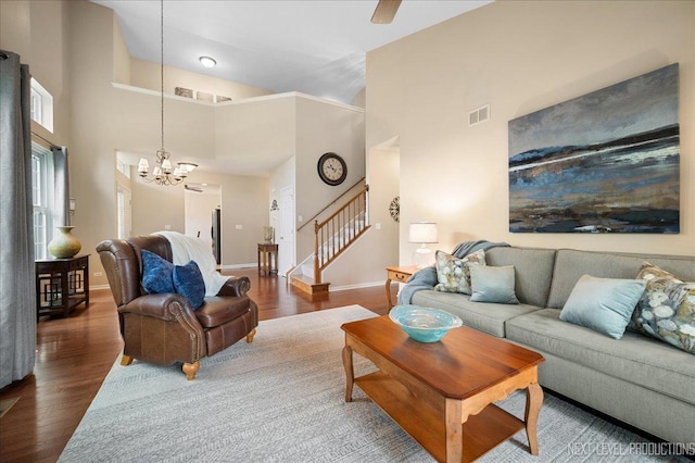 211 Trentt Dr Unit 211, Batavia, IL 60510 - living room with wood finished floors, baseboards, stairs, a chandelier, and high vaulted ceiling