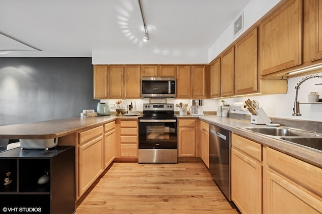 5854 N Kenmore Ave Unit 4F, Chicago, IL 60660 - kitchen with stainless steel appliances, a peninsula, light wood-style flooring, a sink, and open shelves