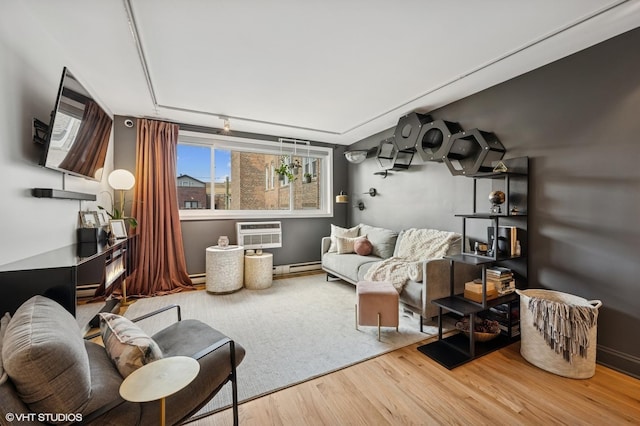 5854 N Kenmore Ave Unit 4F, Chicago, IL 60660 - living room featuring wood finished floors, a wall mounted AC, and a baseboard heating unit