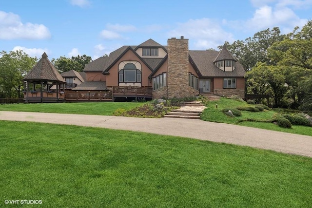 20719 Highview Rd, Marengo, IL 60152 - tudor-style house featuring a front lawn, stone siding, a chimney, and a gazebo