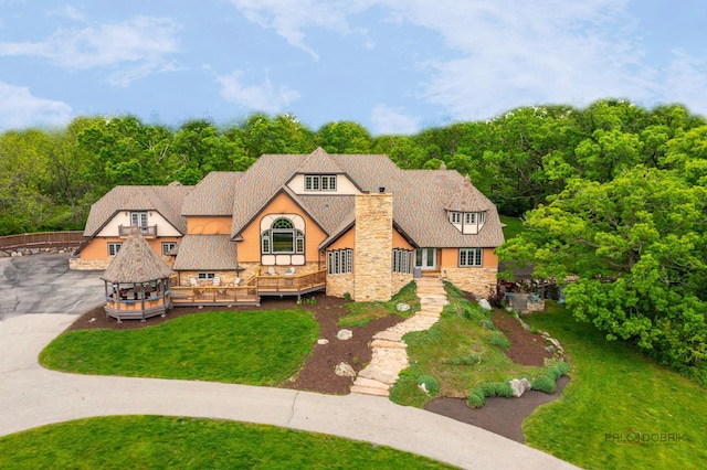 20719 Highview Rd, Marengo, IL 60152 - english style home featuring stone siding, a front lawn, a deck, and stucco siding