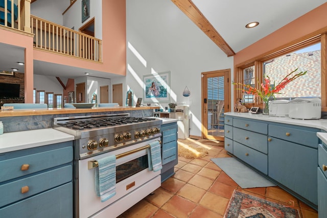 20719 Highview Rd, Marengo, IL 60152 - kitchen featuring gas range, blue cabinetry, beam ceiling, high vaulted ceiling, and plenty of natural light