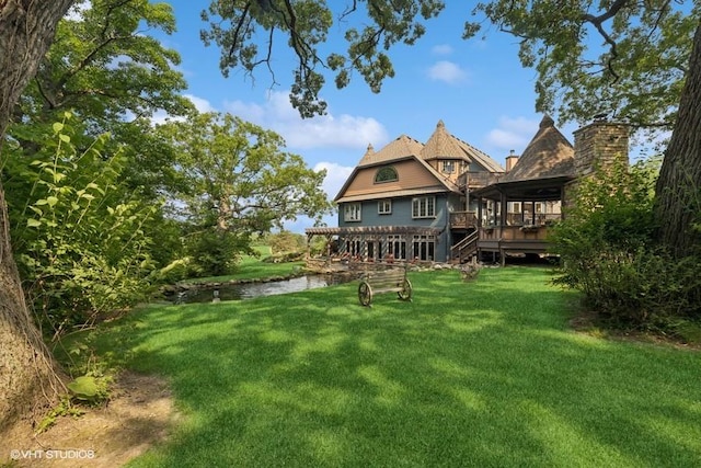 20719 Highview Rd, Marengo, IL 60152 - rear view of house with a lawn, a deck with water view, and stairs