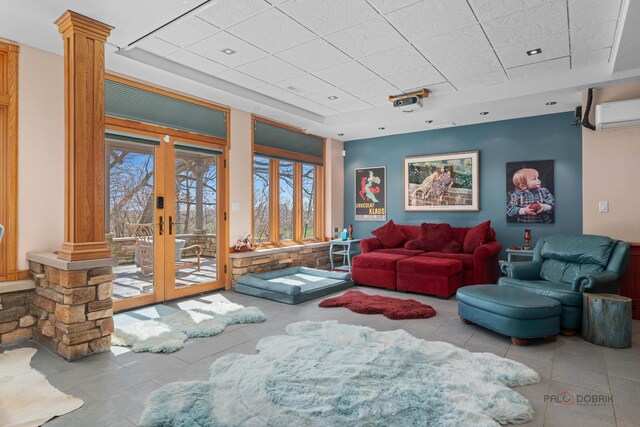 20719 Highview Rd, Marengo, IL 60152 - living room featuring tile patterned floors, ornate columns, a drop ceiling, a wall unit AC, and french doors