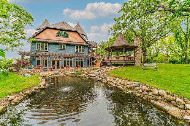 20719 Highview Rd, Marengo, IL 60152 - back of property with a lawn, a wooden deck, a garden pond, and a patio area