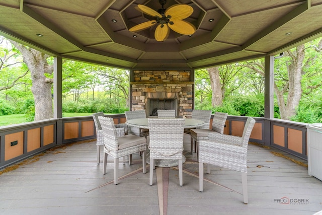 20719 Highview Rd, Marengo, IL 60152 - wooden deck featuring an outdoor stone fireplace, outdoor dining area, a gazebo, and a ceiling fan