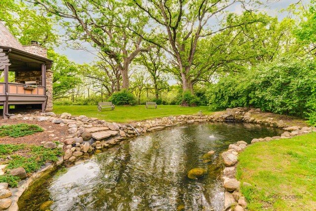 20719 Highview Rd, Marengo, IL 60152 - view of green lawn featuring a garden pond and a wooden deck