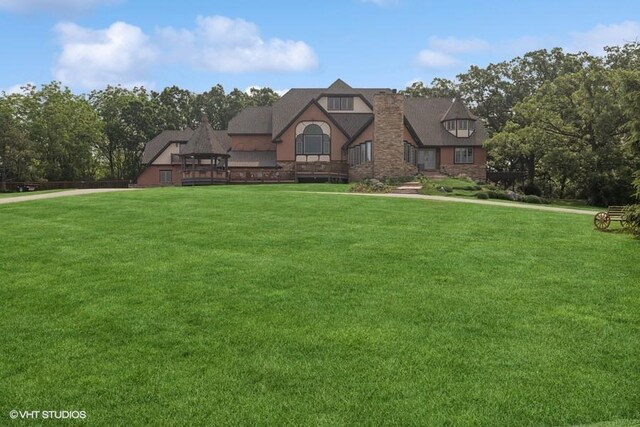 20719 Highview Rd, Marengo, IL 60152 - tudor house featuring a front lawn, a chimney, and stone siding