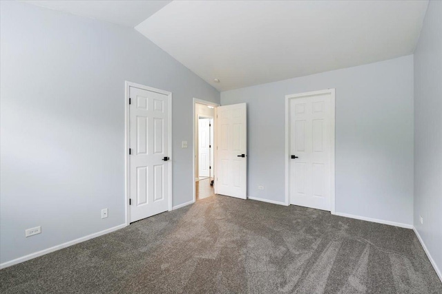 1300 Woodside Ct Unit B2, Schaumburg, IL 60193 - unfurnished bedroom featuring dark carpet, vaulted ceiling, and baseboards