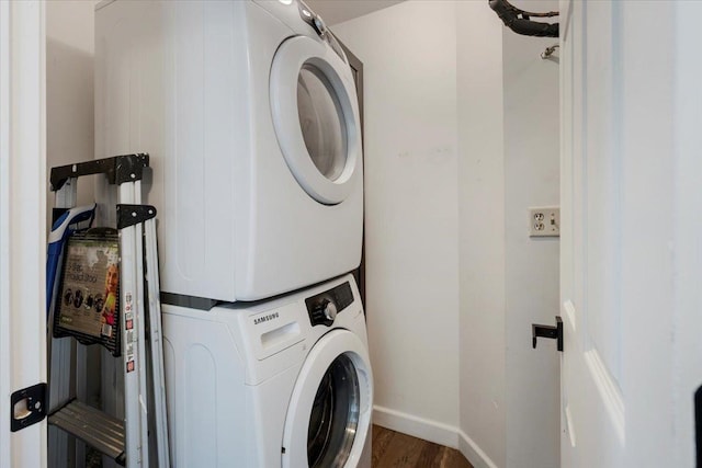 1300 Woodside Ct Unit B2, Schaumburg, IL 60193 - washroom with stacked washing machine and dryer, baseboards, and wood finished floors