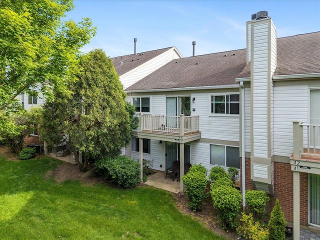 1300 Woodside Ct Unit B2, Schaumburg, IL 60193 - back of property featuring a lawn, roof with shingles, a chimney, and a patio