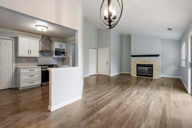 1300 Woodside Ct Unit B2, Schaumburg, IL 60193 - kitchen with stainless steel appliances, wall chimney range hood, light countertops, and dark wood-style floors
