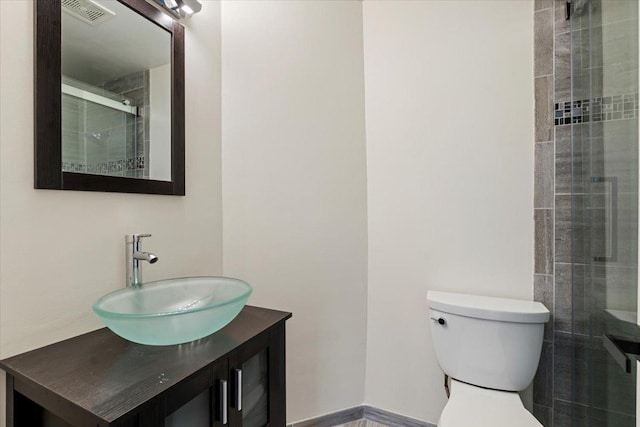 1300 Woodside Ct Unit B2, Schaumburg, IL 60193 - bathroom featuring vanity, toilet, and tiled shower