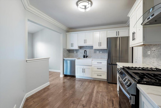 1300 Woodside Ct Unit B2, Schaumburg, IL 60193 - kitchen featuring appliances with stainless steel finishes, wall chimney range hood, ornamental molding, backsplash, and white cabinetry