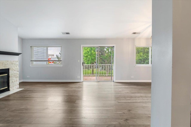 1300 Woodside Ct Unit B2, Schaumburg, IL 60193 - unfurnished living room with wood-type flooring, a fireplace, and baseboards
