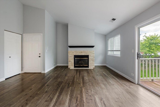 1300 Woodside Ct Unit B2, Schaumburg, IL 60193 - unfurnished living room with wood finished floors, a fireplace, baseboards, and lofted ceiling