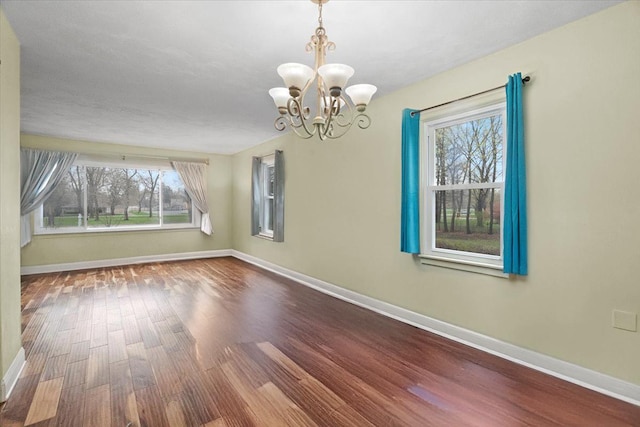 2906 Bethel Blvd, Zion, IL 60099 - unfurnished room featuring wood finished floors, baseboards, and a chandelier