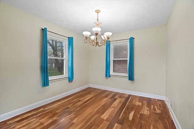 2906 Bethel Blvd, Zion, IL 60099 - empty room featuring a chandelier, wood finished floors, and baseboards