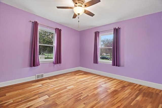 2906 Bethel Blvd, Zion, IL 60099 - spare room featuring wood finished floors, plenty of natural light, and baseboards