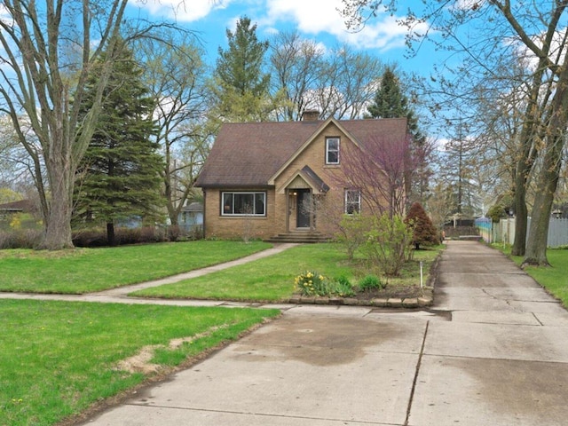 2906 Bethel Blvd, Zion, IL 60099 - view of front facade featuring a chimney, a front lawn, brick siding, and concrete driveway