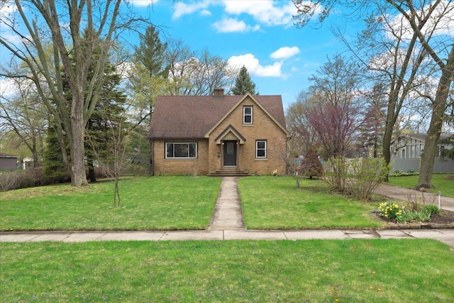 2906 Bethel Blvd, Zion, IL 60099 - view of front facade featuring a front lawn, brick siding, and a chimney