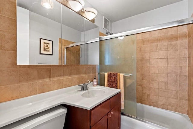 655 W Irving Park Rd Unit 4212, Chicago, IL 60613 - bathroom with tile walls, vanity, toilet, and bath / shower combo with glass door