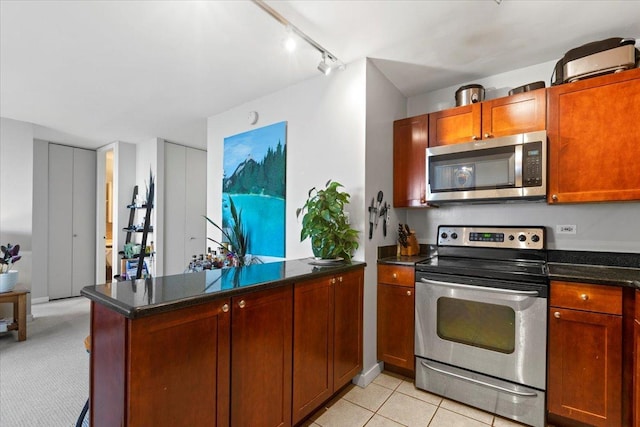 655 W Irving Park Rd Unit 4212, Chicago, IL 60613 - kitchen featuring appliances with stainless steel finishes, a peninsula, track lighting, and brown cabinetry