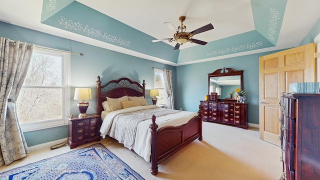 316 Juliana Ln, Bloomingdale, IL 60108 - carpeted bedroom with a tray ceiling, baseboards, and ceiling fan