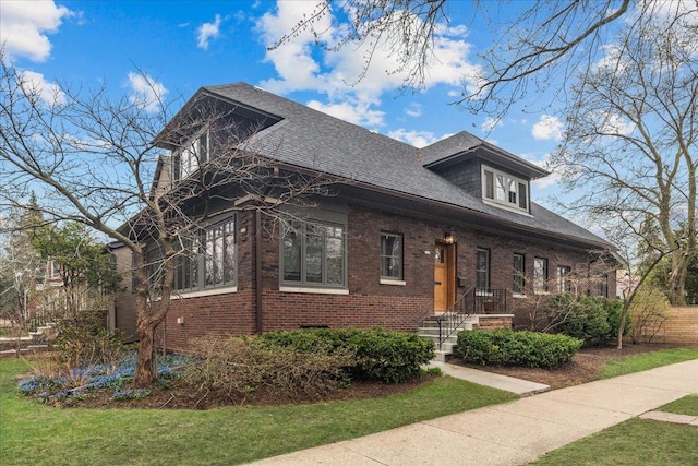 2087 W Greenleaf Ave, Chicago, IL 60645 - view of front facade with brick siding, a front yard, and a shingled roof