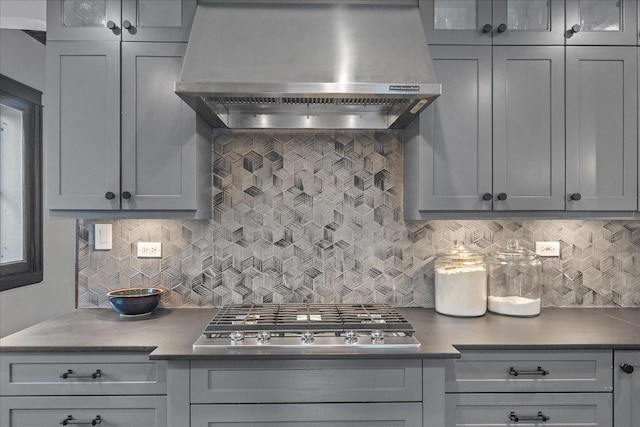 2087 W Greenleaf Ave, Chicago, IL 60645 - kitchen with extractor fan, stainless steel gas stovetop, tasteful backsplash, gray cabinets, and glass insert cabinets