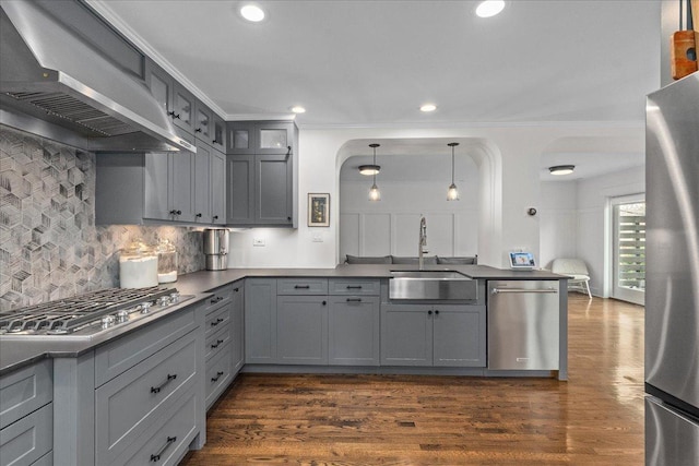 2087 W Greenleaf Ave, Chicago, IL 60645 - kitchen with stainless steel appliances, wall chimney range hood, a sink, gray cabinetry, and decorative backsplash