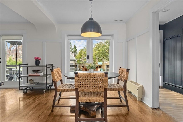 2087 W Greenleaf Ave, Chicago, IL 60645 - dining space with a decorative wall, wood finished floors, and ornamental molding