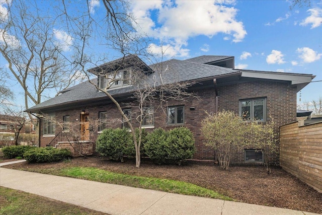 2087 W Greenleaf Ave, Chicago, IL 60645 - view of side of property featuring brick siding and a shingled roof