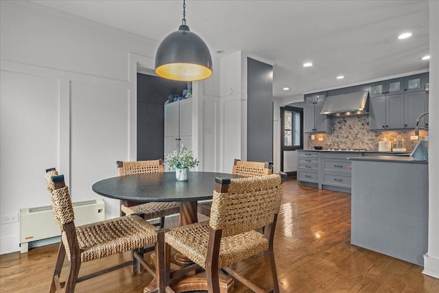 2087 W Greenleaf Ave, Chicago, IL 60645 - dining space featuring radiator, dark wood-type flooring, recessed lighting, and crown molding