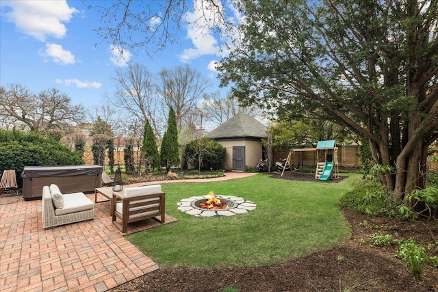2087 W Greenleaf Ave, Chicago, IL 60645 - view of yard featuring a hot tub, a patio, a playground, an outdoor fire pit, and an outbuilding